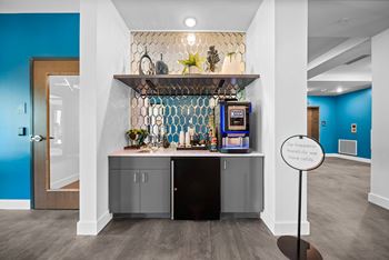 A small bar area with a sign that says "So happy we have refills".